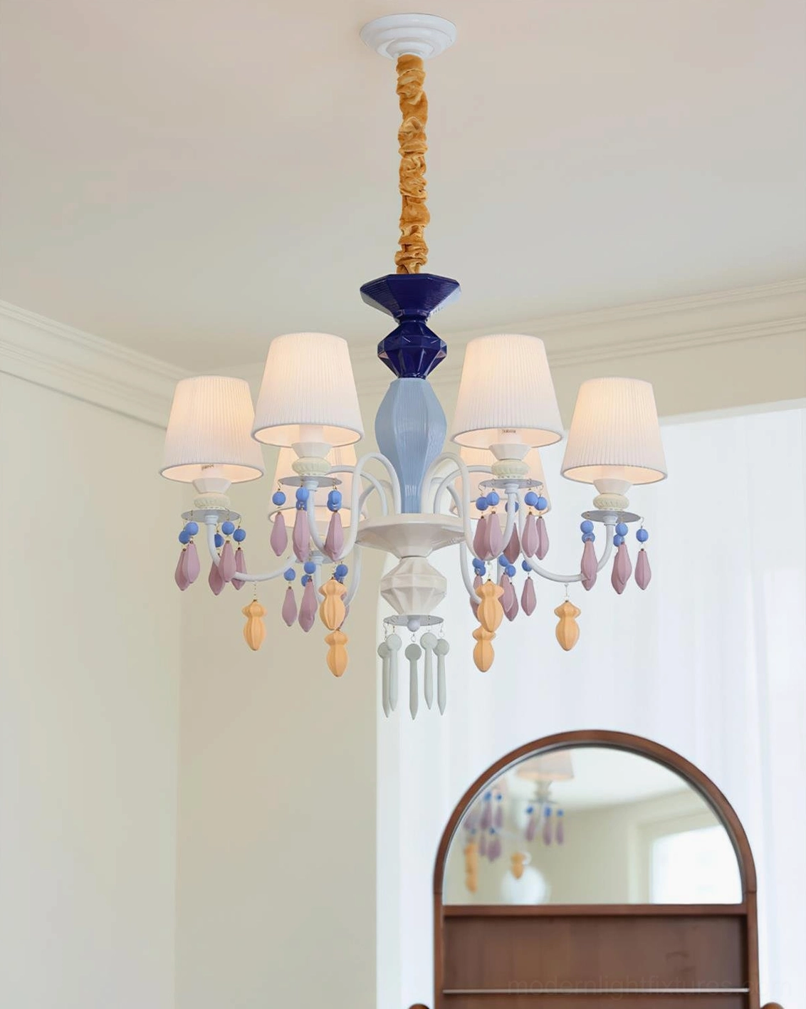 Wide view of large ceramic chandelier in bright contemporary living room with arched architectural features