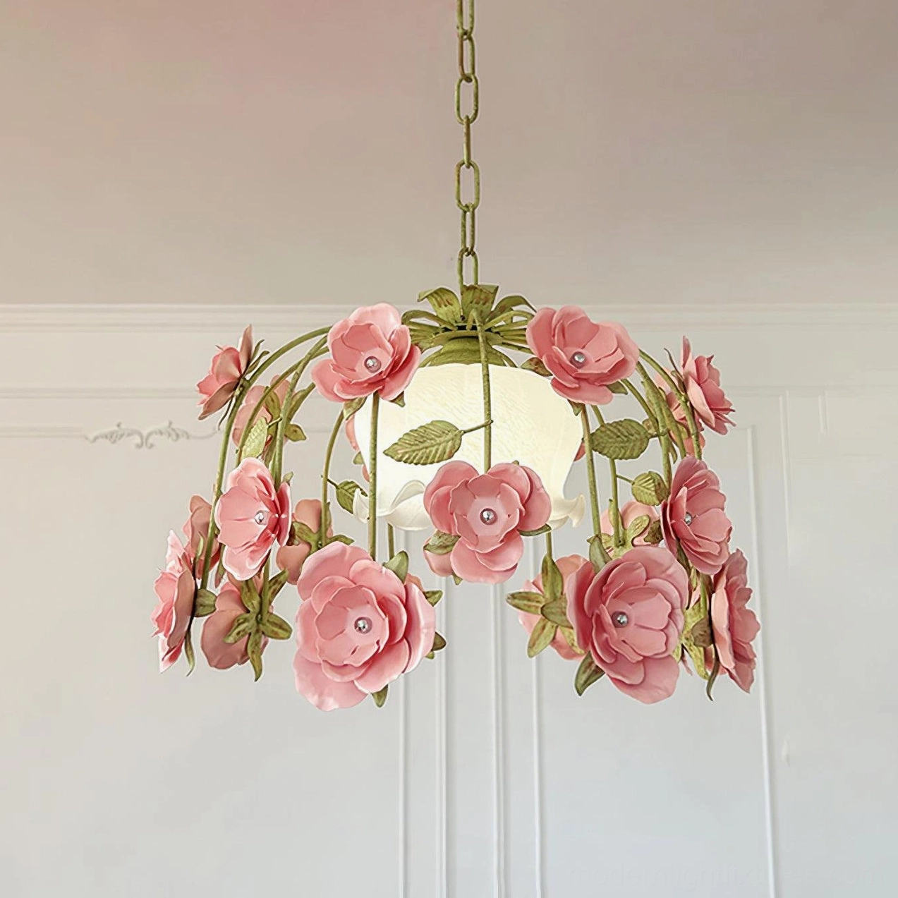 Large hand-carved floral pendant light 47cm with dark pink roses and green metal hardware against French interior panel wall