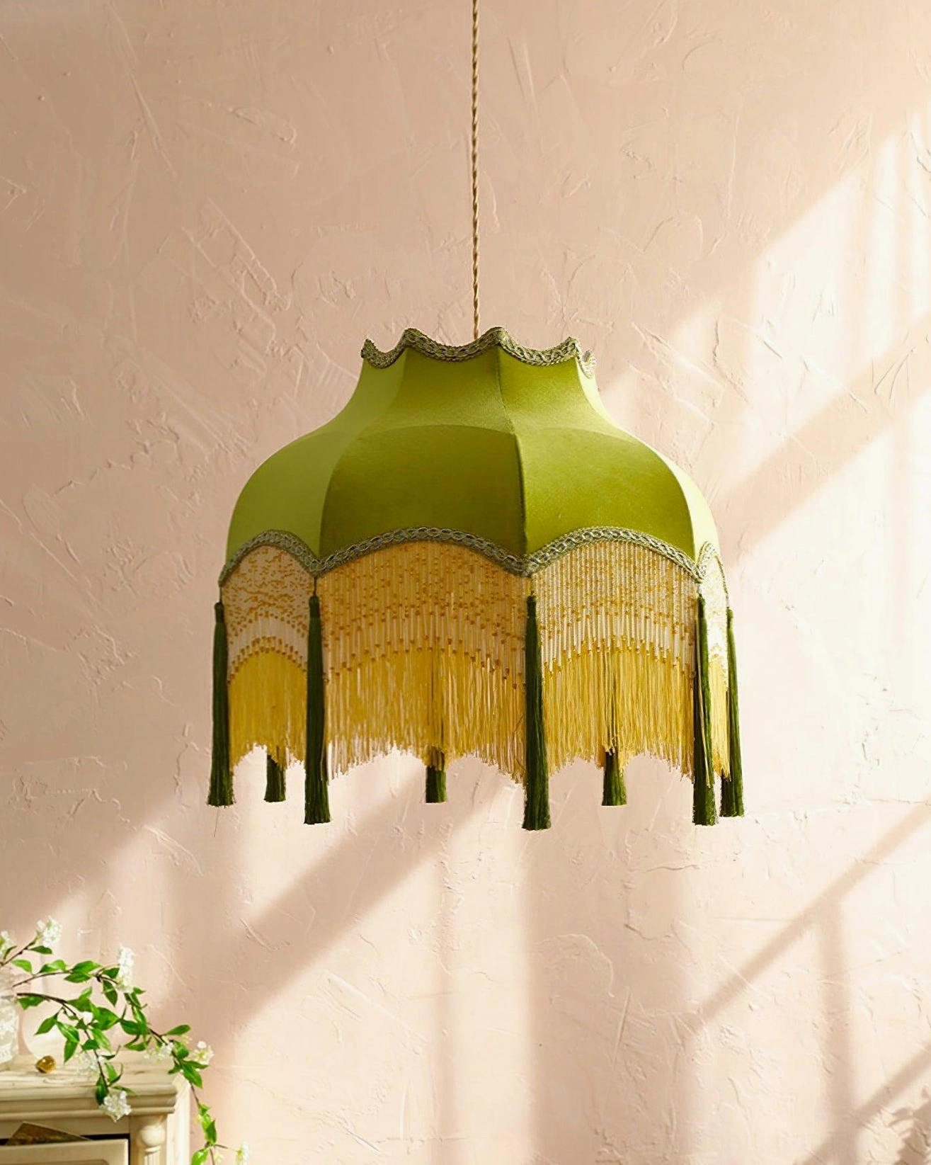 Large green tassel pendant light showcasing full scalloped shade design