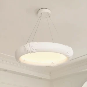 Large diameter white plaster chandelier pendant with embossed shell detailing overhead ceiling view