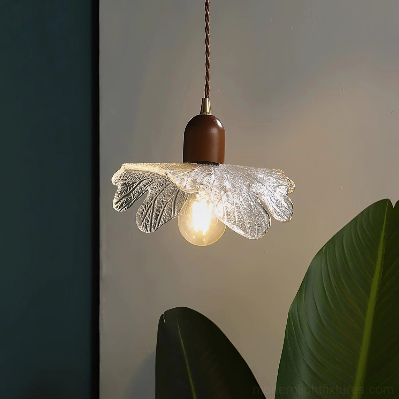 Statement-size petal glass pendant light with warm amber bulb glow in contemporary space