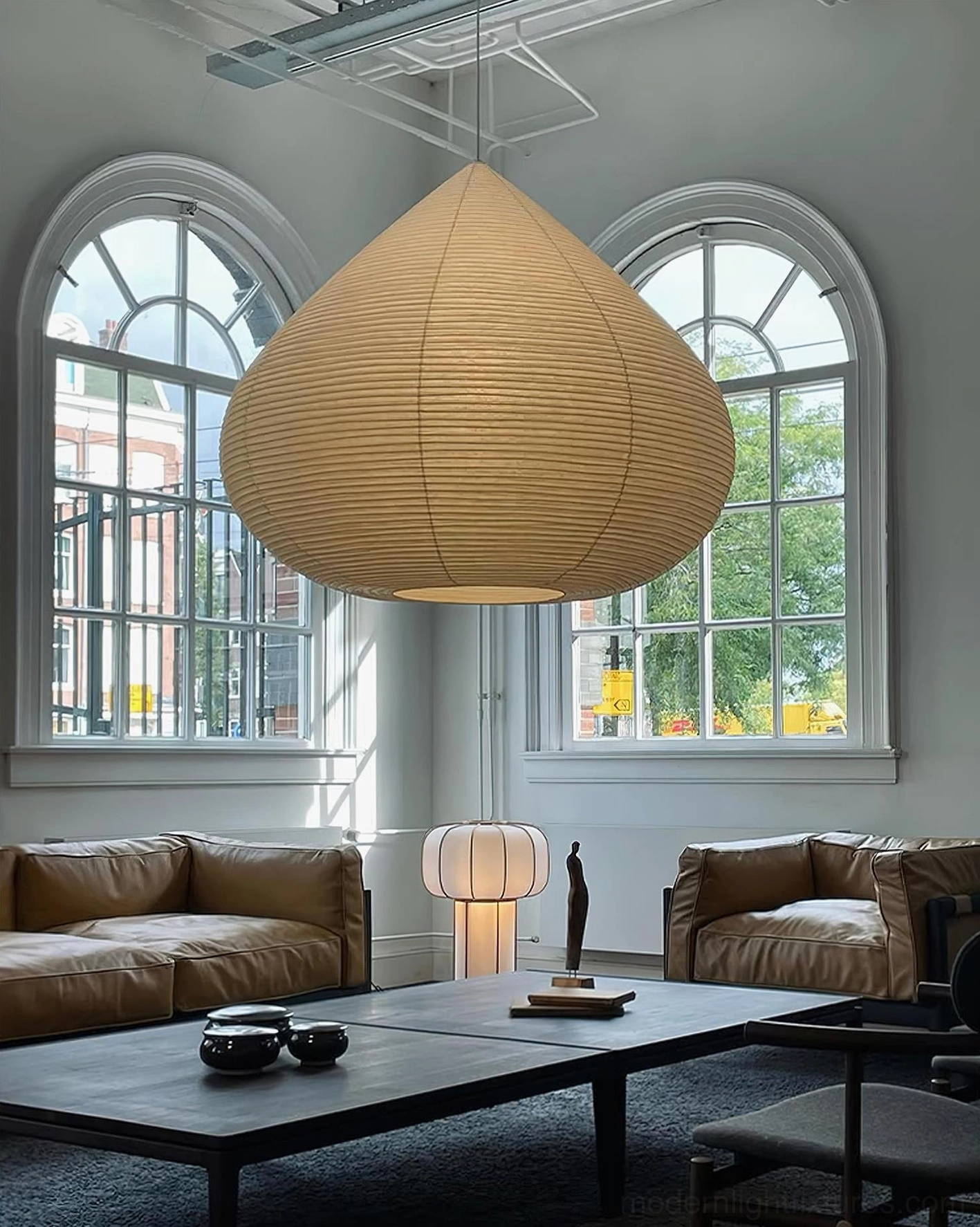 Large illuminated chestnut pendant lamp creating ambient lighting in luxury living room