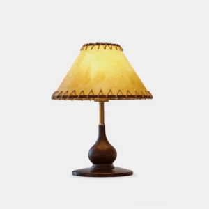 Lariat stitched leather table lamp with carved wood base and jute binding, front studio view