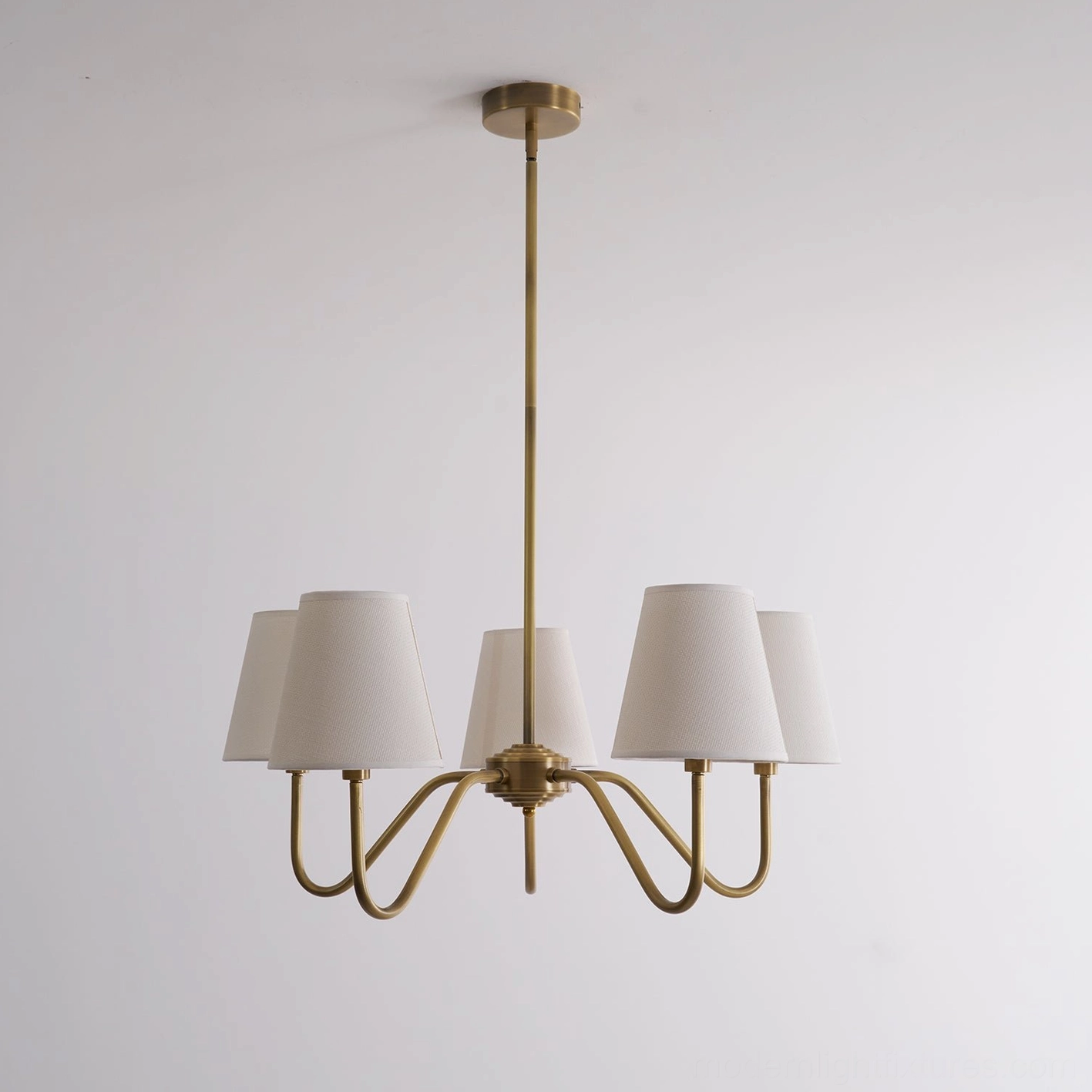 Lassen brass chandelier architectural detail, curved arms, fabric shade construction, modern fixture design