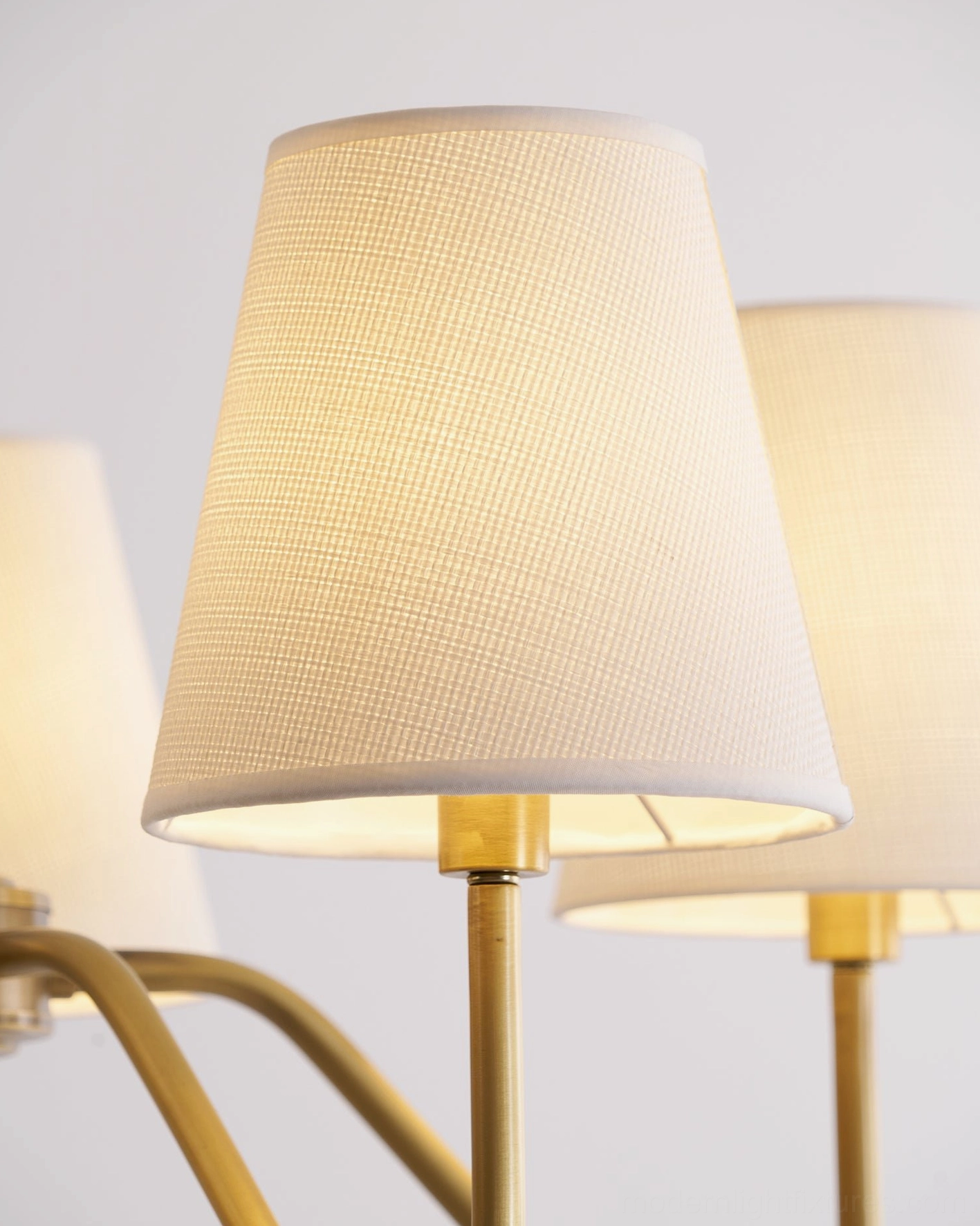 Lassen brass chandelier close-up detail, fabric shade texture, brass finish quality, material craftsmanship