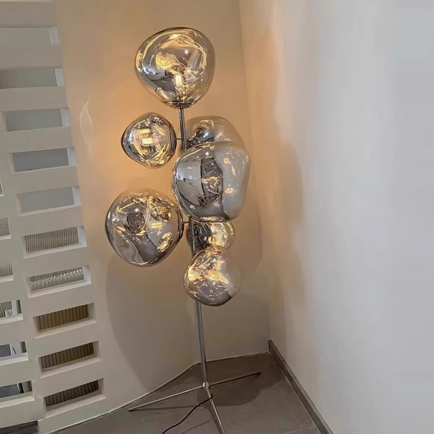 Bronze bubble floor lamp with warm gold finish creating dramatic focal point in room