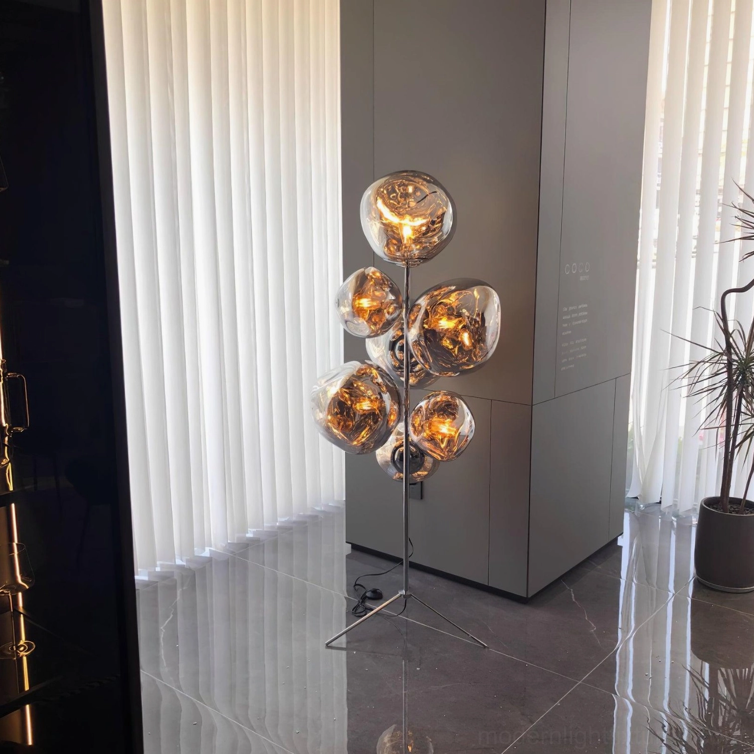 Close-up macro detail of bronze illuminated bubble glass shades with reflective metallic finish