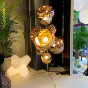 Modern bronze bubble floor lamp in cozy living room with green plants and warm lighting