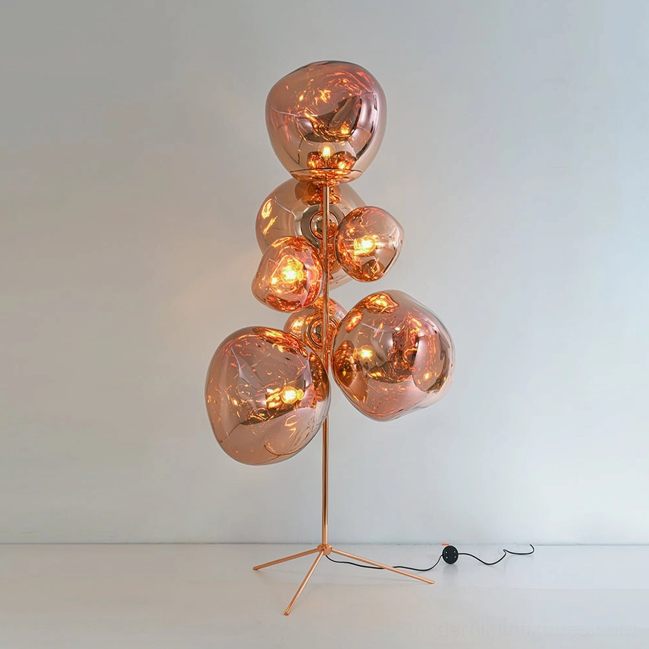 Large lava bubble floor lamp illuminated showing warm glass glow in dark room