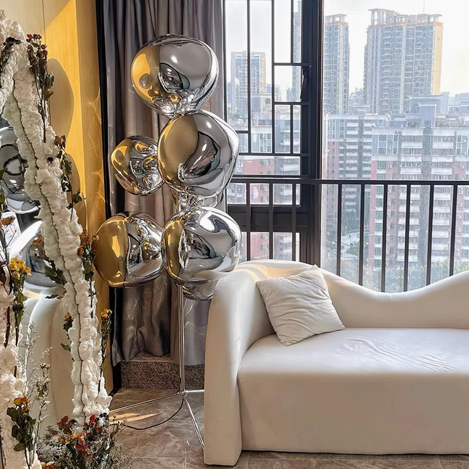 Silver chrome bubble floor lamp with tripod base in minimalist luxury interior