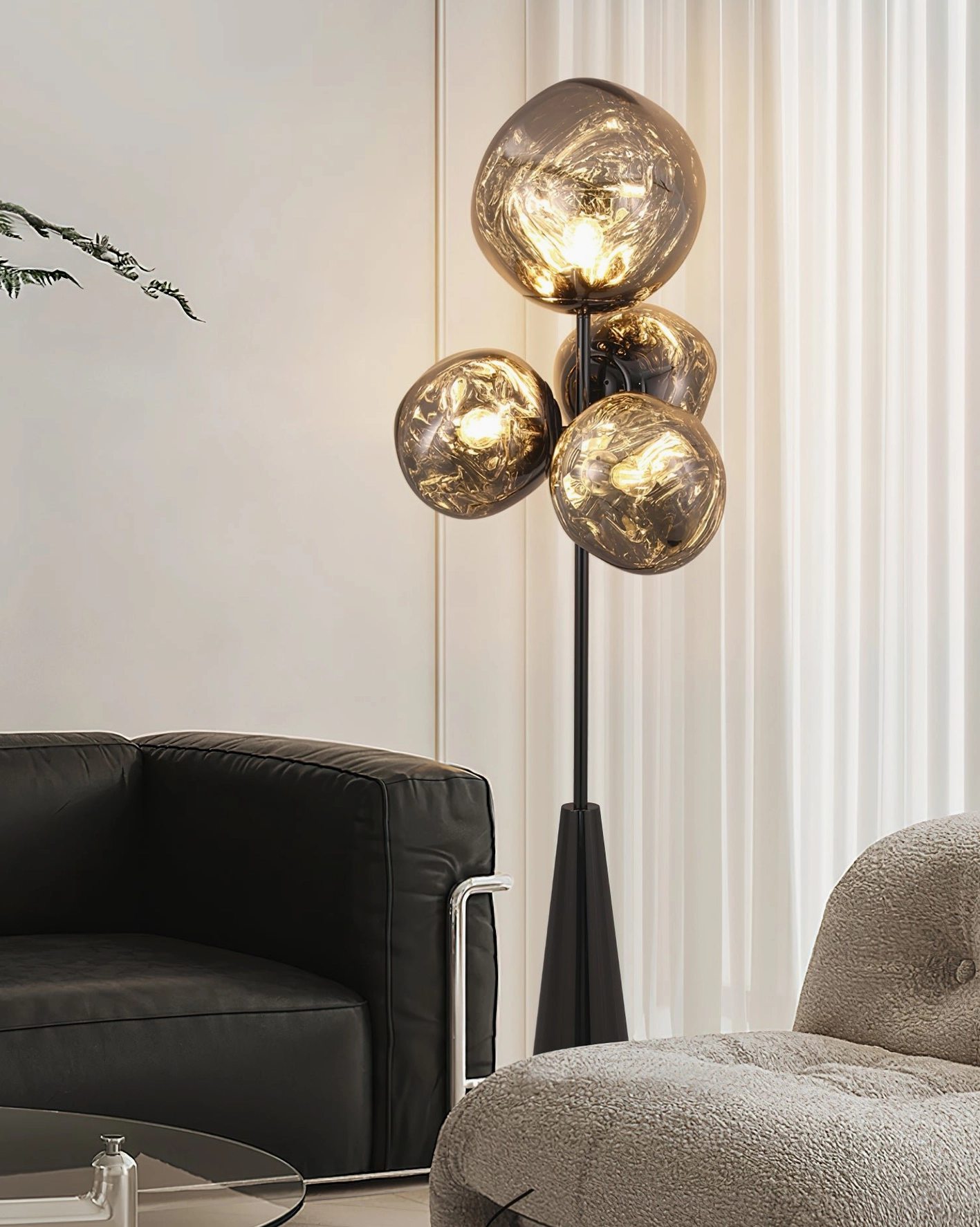 Lava glass ball floor lamp side angle with warm glowing light effect - black hardware and smoked brown glass in living room