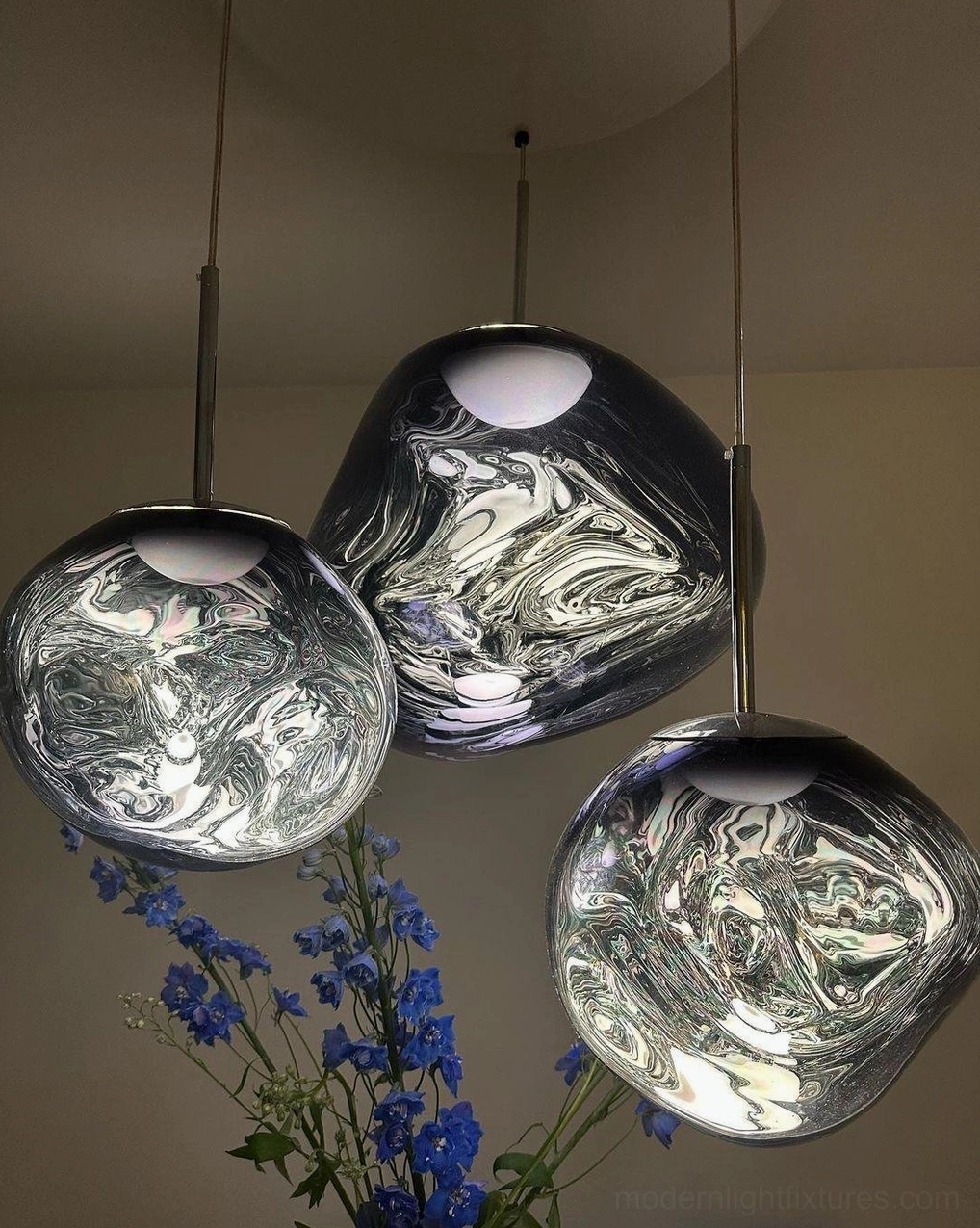 Pendant light metallic shade creating fractured light pattern ambiance