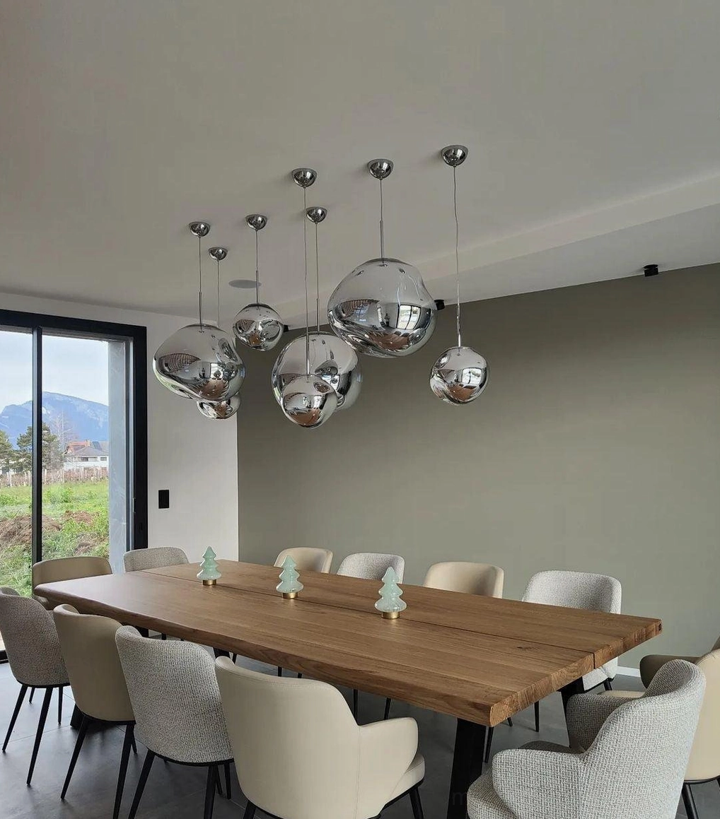 Chrome lava pendant lamps creating ambient fractured light in modern dining room