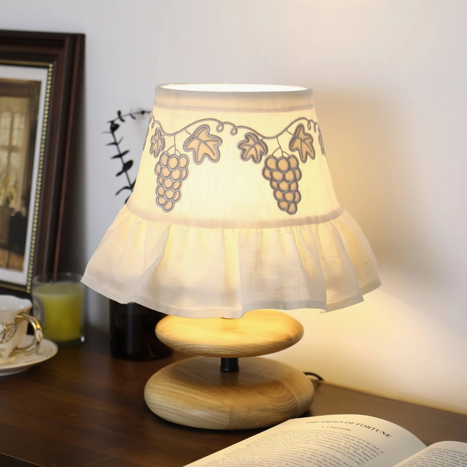 Lavelle pleated fabric table lamp close-up detail lit warm light wooden desk