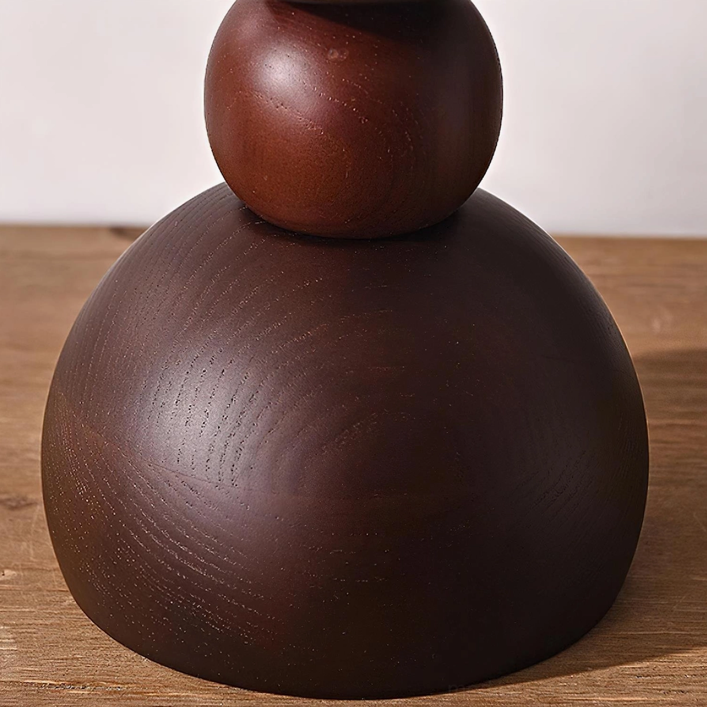 Modern walnut wood table lamp with layered base and soft diffusing fabric shade for contemporary interiors