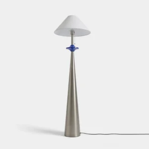 Lazuro cone floor lamp with matte stainless steel tapered base, blue decorative disc, and white cotton-linen coolie shade, studio front view