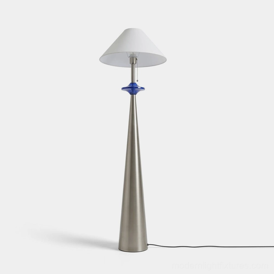 Lazuro cone floor lamp with matte stainless steel tapered base, blue decorative disc, and white cotton-linen coolie shade, studio front view