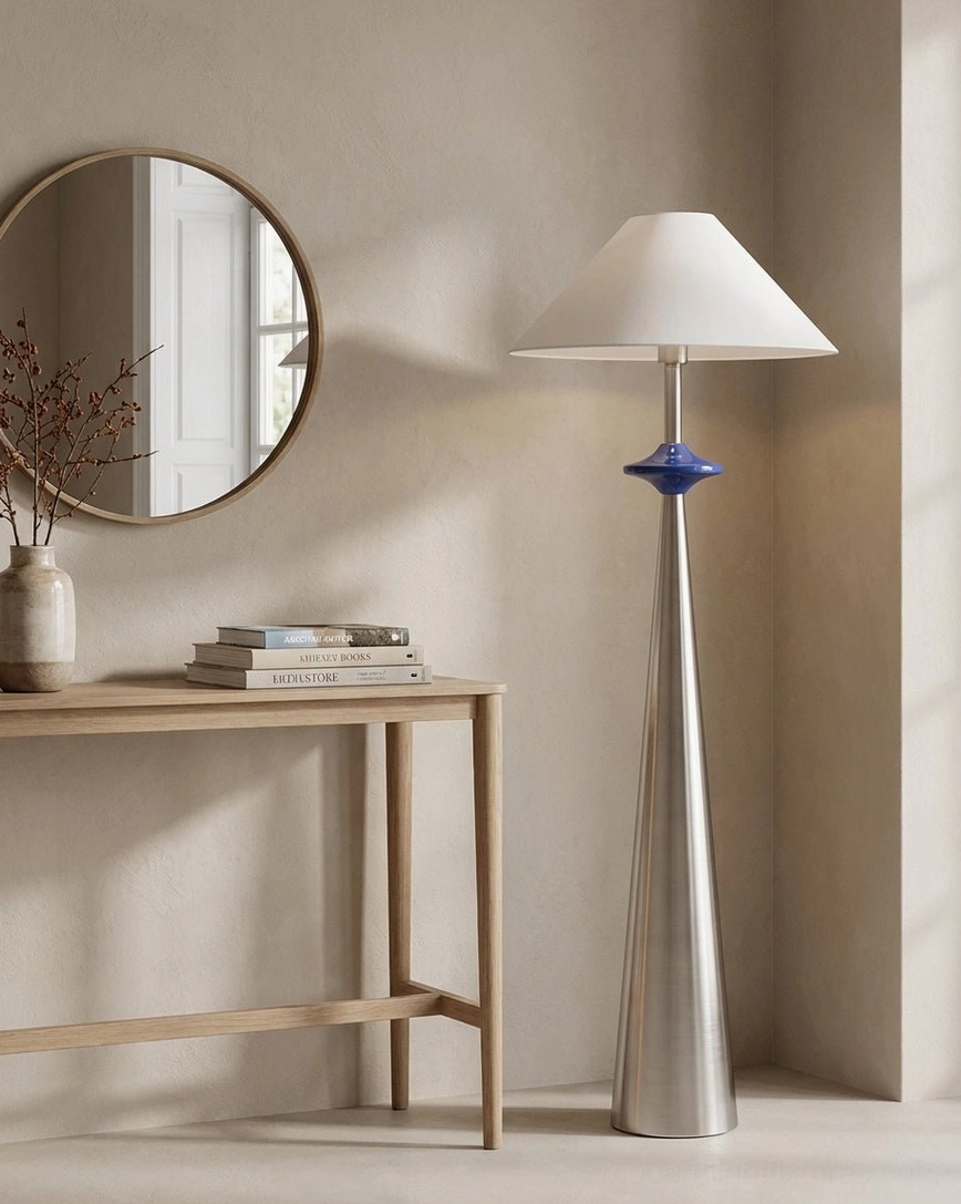 Matte stainless steel cone floor lamp with white linen shade in Scandinavian interior, minimalist design aesthetic