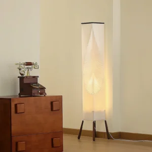 Botanical floor lamp creating warm ambient lighting in vintage interior with wooden cabinet