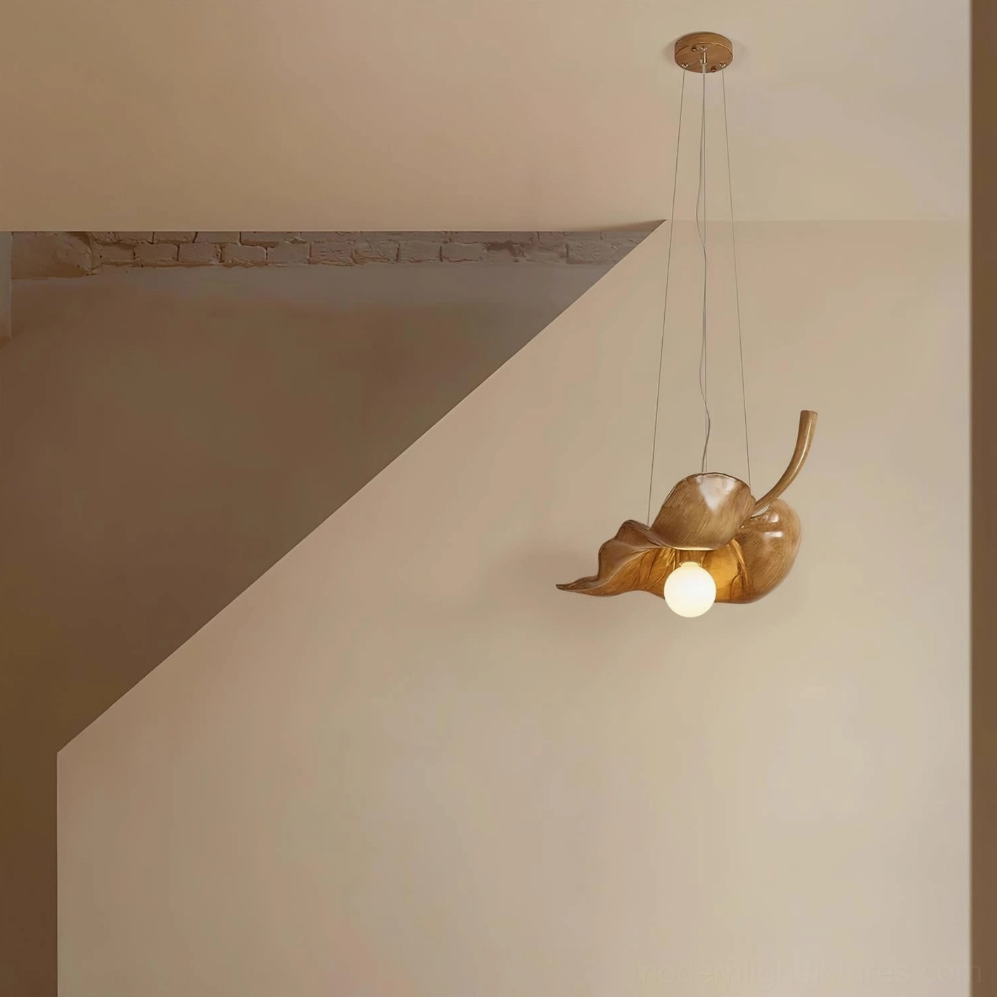 Maple leaf pendant light hanging in residential stairwell interior, warm ambient lighting in modern home
