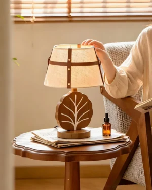 Leafora modern table lamp styled on wooden side table in cozy living room interior, next to magazines and botanical décor, warm lighting ambiance