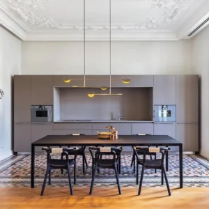 Leaves pendant chandelier installed in contemporary open-plan kitchen and dining space with warm brass finish