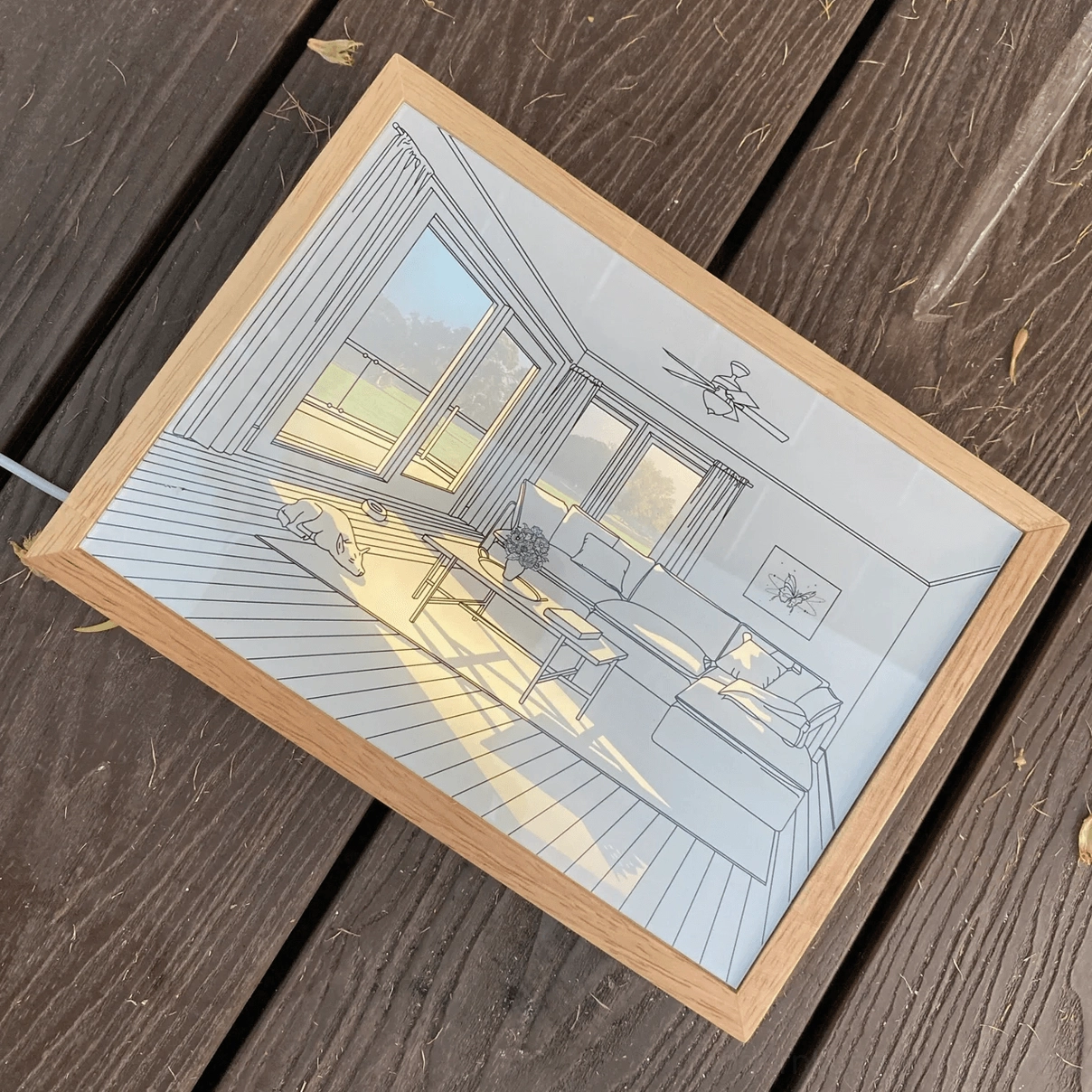 Modern acrylic art light with transparent panel and natural wood frame overhead view