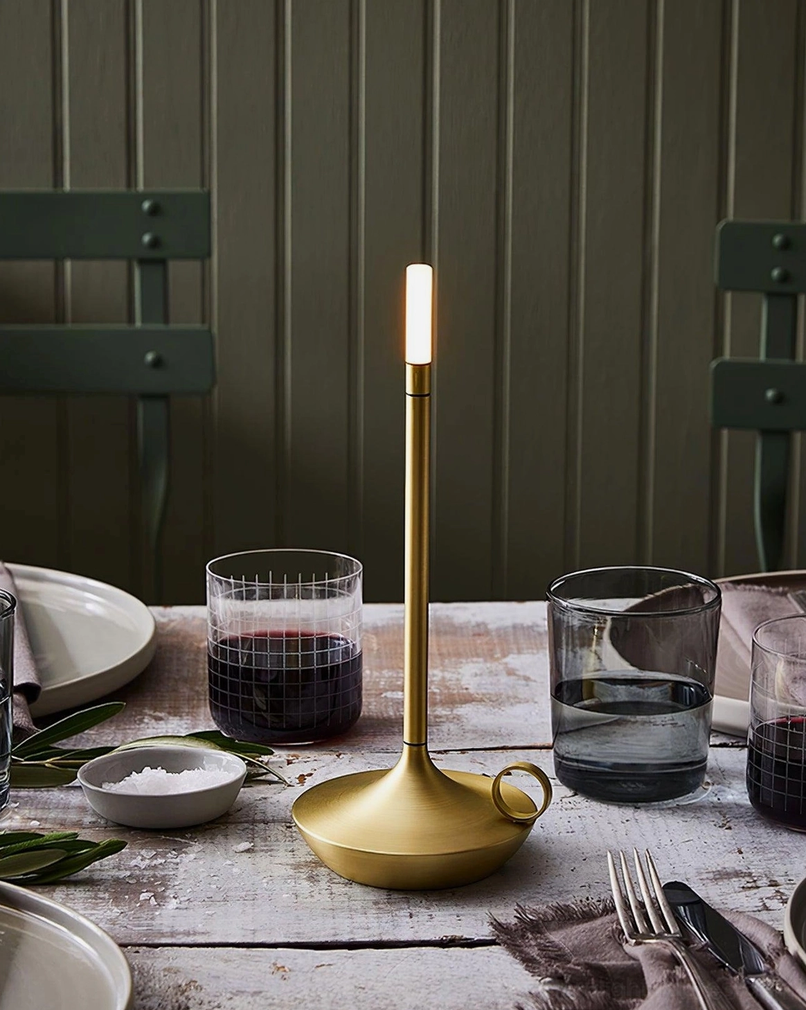 Contemporary LED candle table lamp creating layered warm lighting in minimalist interior space with refined styling