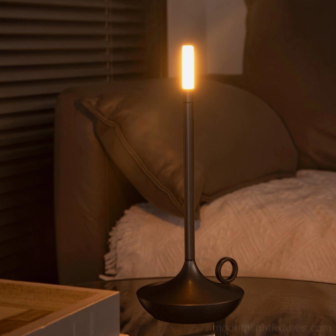 Minimalist LED candle table lamp providing layered ambient warm lighting in transitional interior spaces
