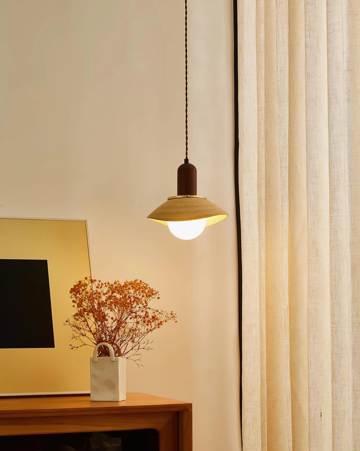 Warm ambient light from Legro ceramic pendant in minimalist home space with curtain and wall art