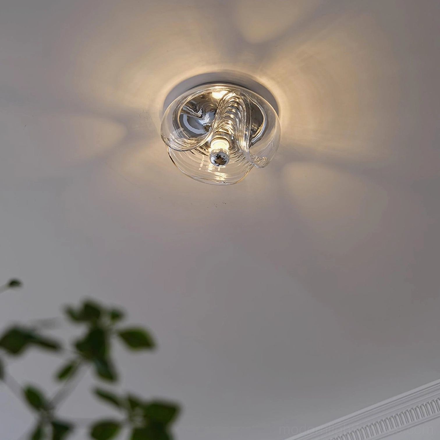 Wave glass ceiling lamp overhead view projecting soft radial warm light