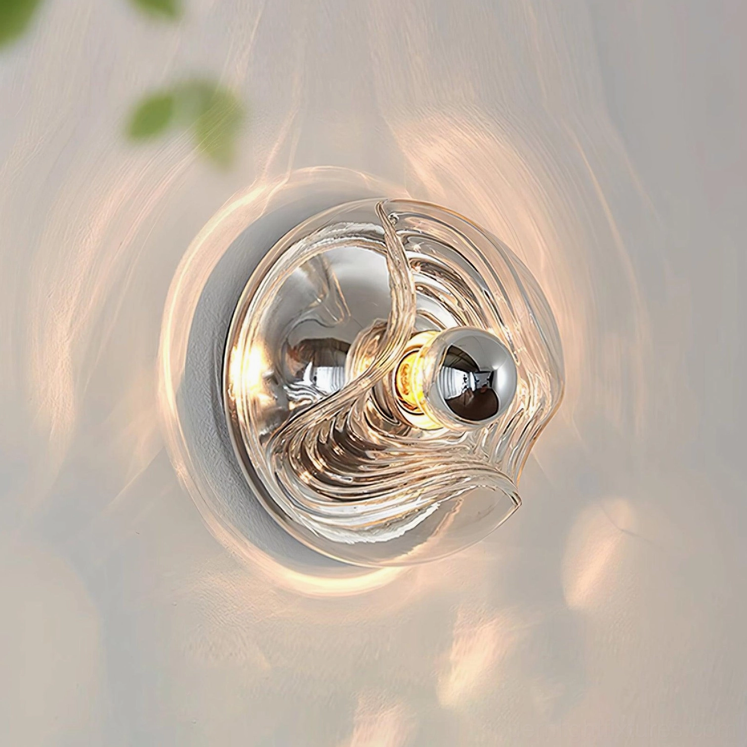 Modern ripple glass wall sconce overhead illuminated view casting warm radial light pattern