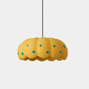 Lemon-yellow modern pendant light with teal polka dots, studio front view, scalloped edge design