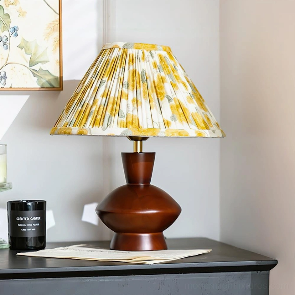 Lenora Model A gourd-shaped table lamp with yellow floral pleated shade, three-quarter side view with artwork