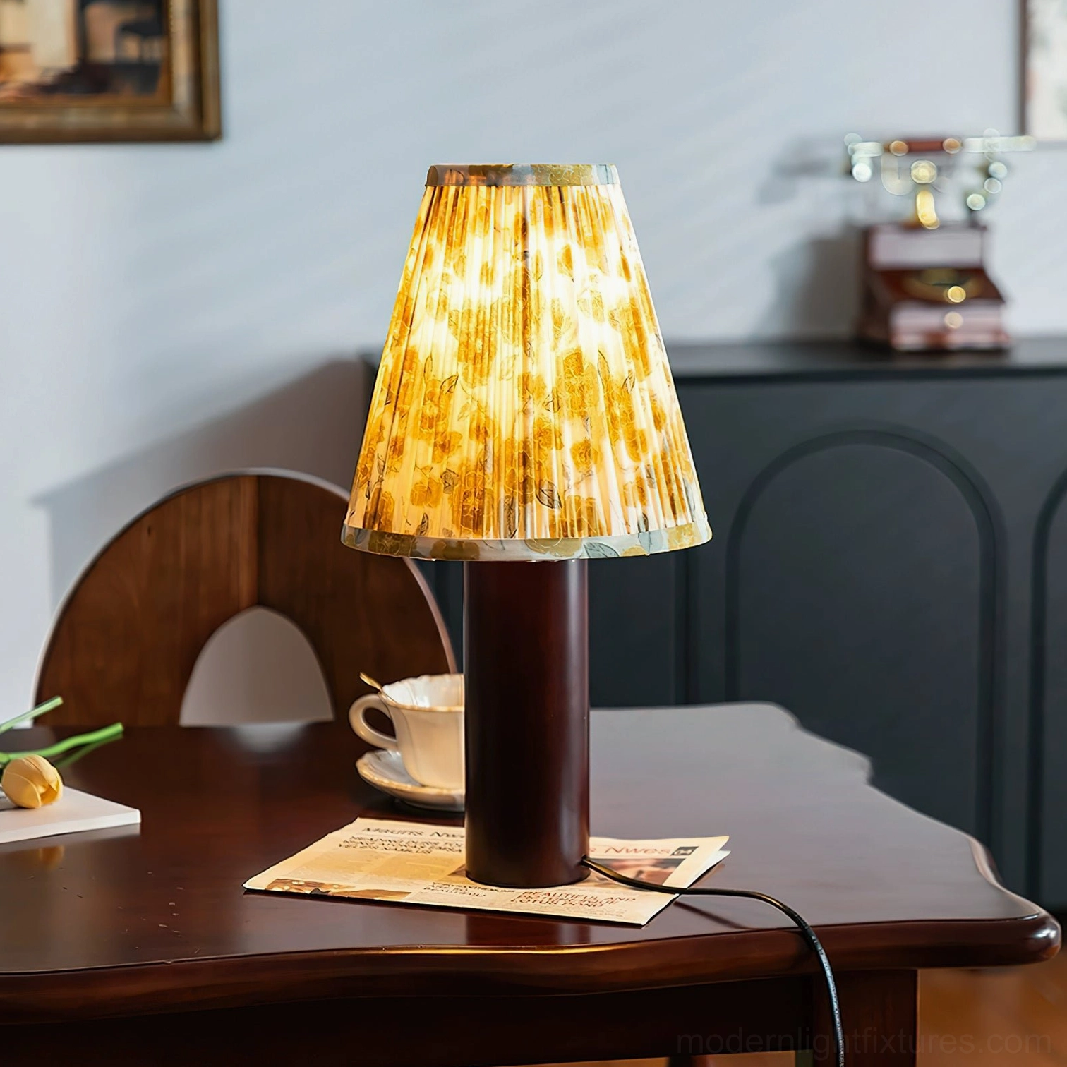 Lenora cylindrical table lamp with yellow floral pleated shade in home dining room setting with tableware