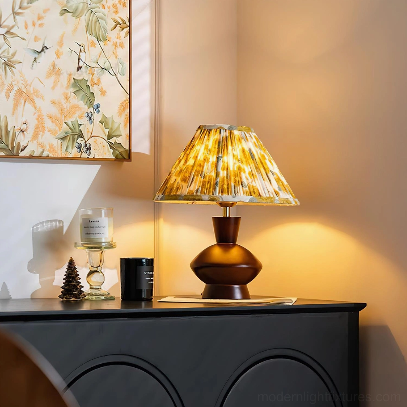 Lenora gourd-base table lamp with yellow floral pleated shade on side table with decorative pine cone