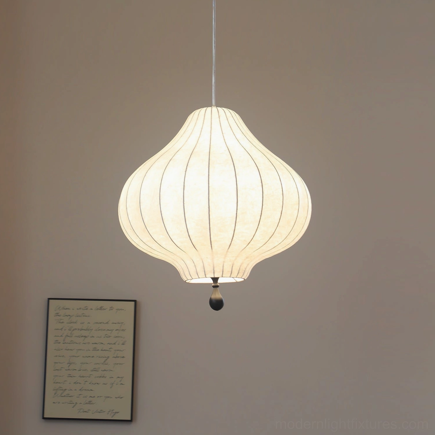 Leocadia striped pendant lamp three-quarter view showing onion-shaped silhouette and warm illumination