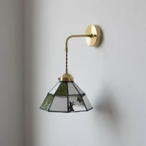 Brass and green stained glass wall lamp with rabbit motifs three-quarter perspective