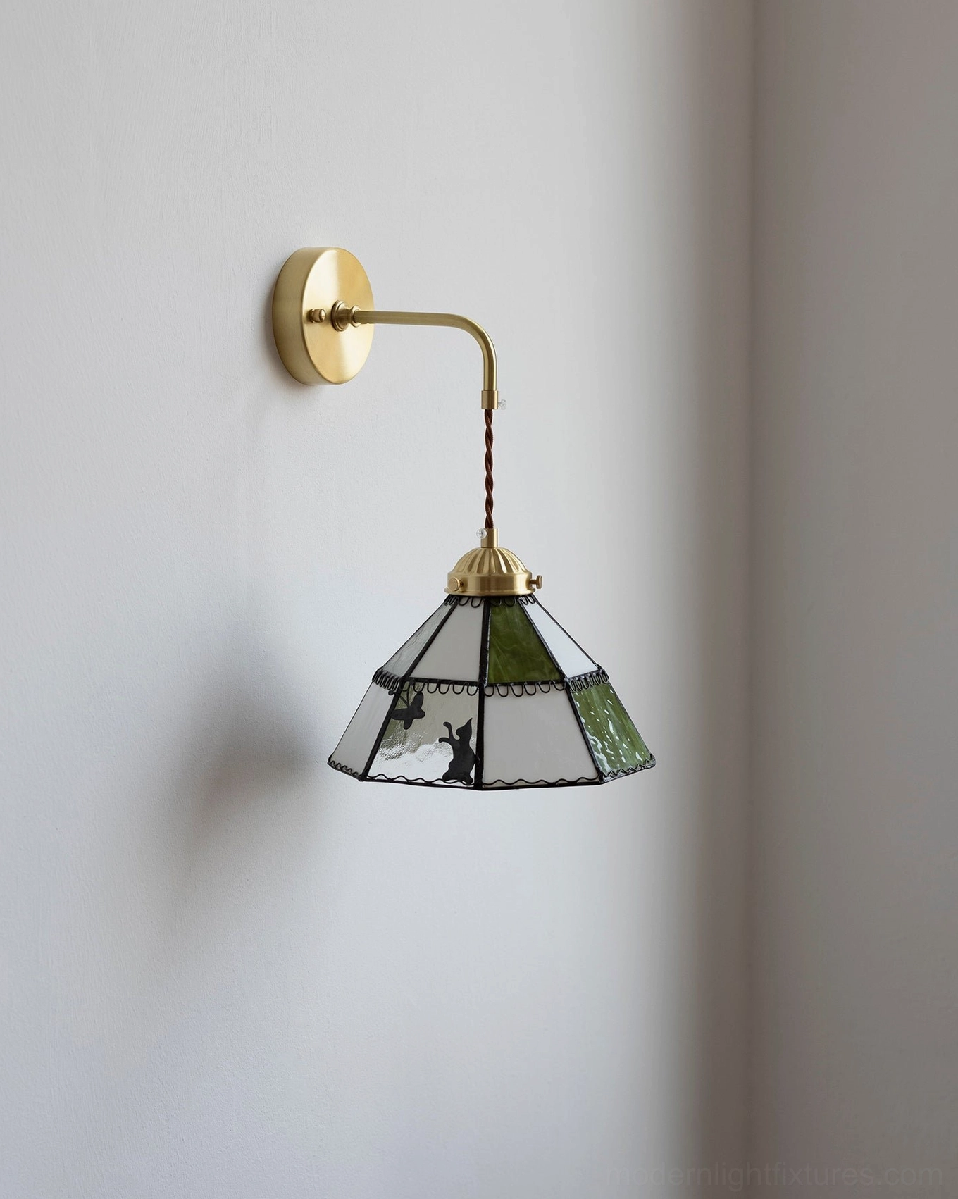 Green and brass stained glass wall sconce with twisted fabric cord