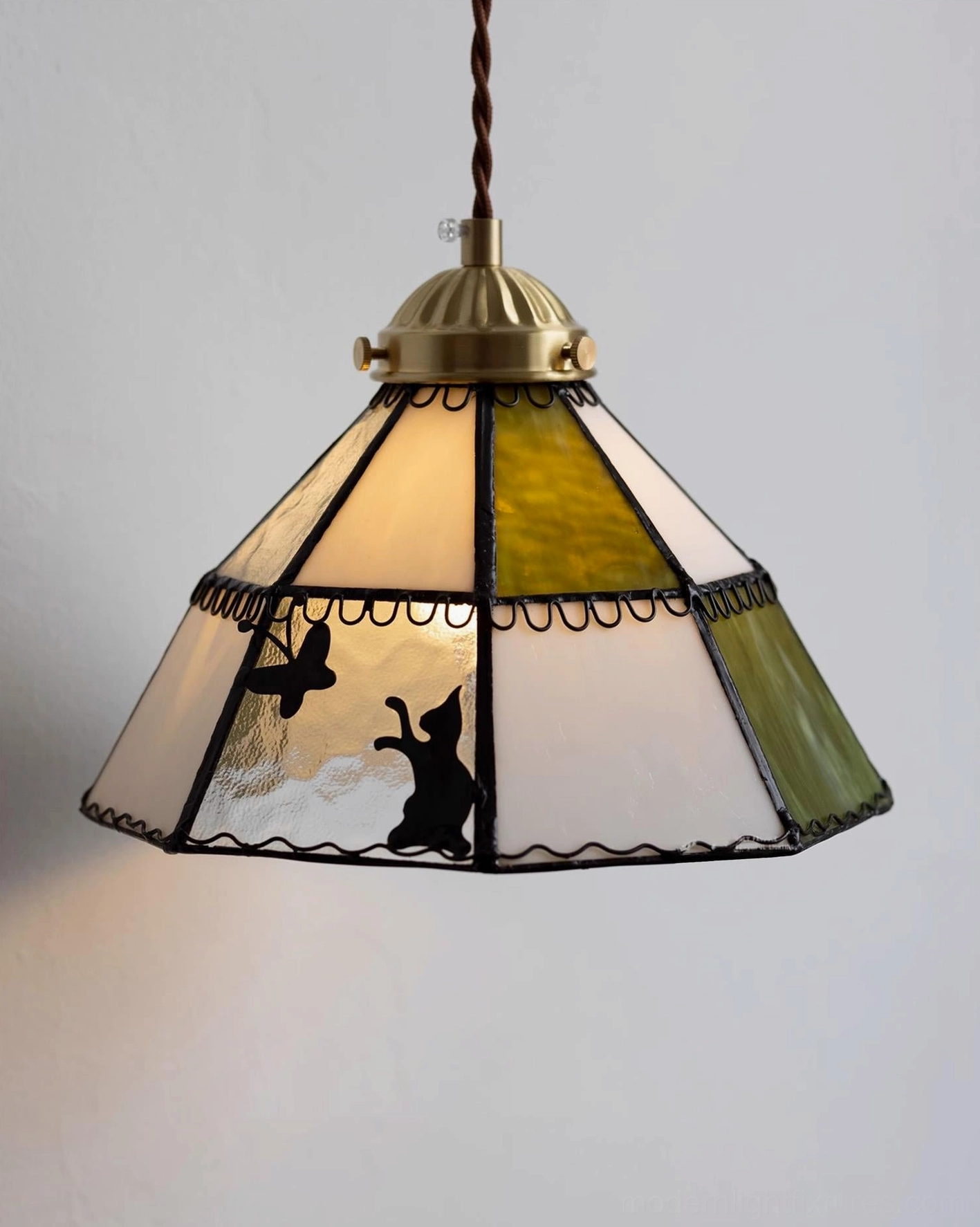 Tiffany-style wall sconce with hand-crafted stained glass rabbit panels and brass hardware