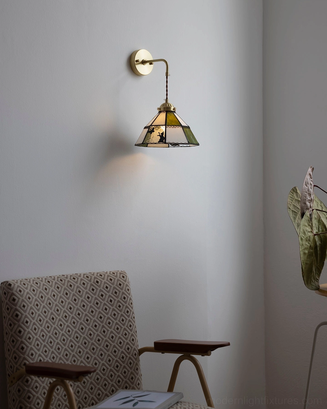 Overhead view of compact brass stained glass wall sconce in residential space