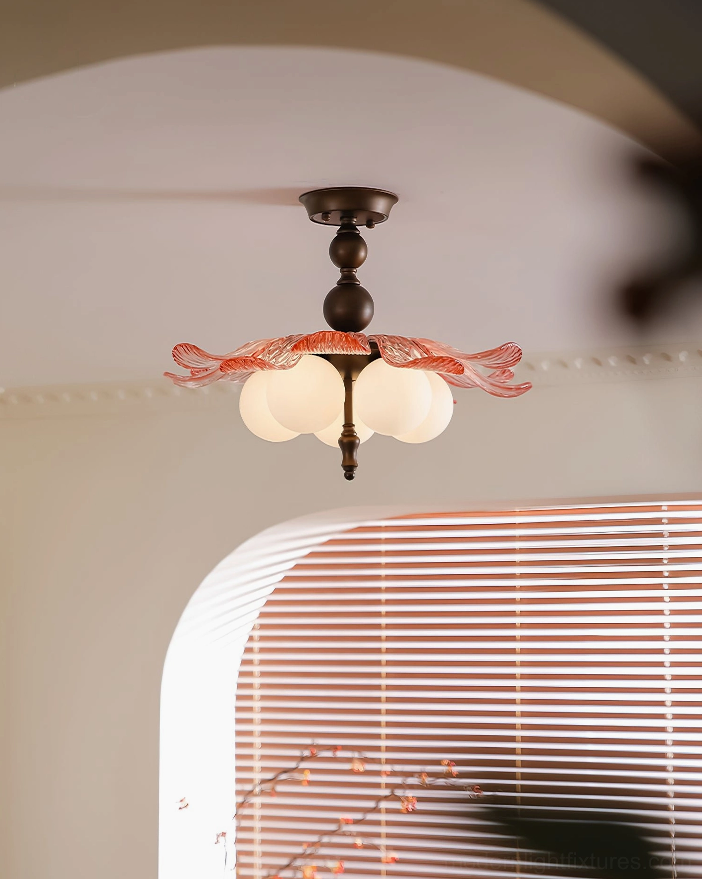 Levara ceiling light fixture with clear glass petals and dark bronze metalwork detail