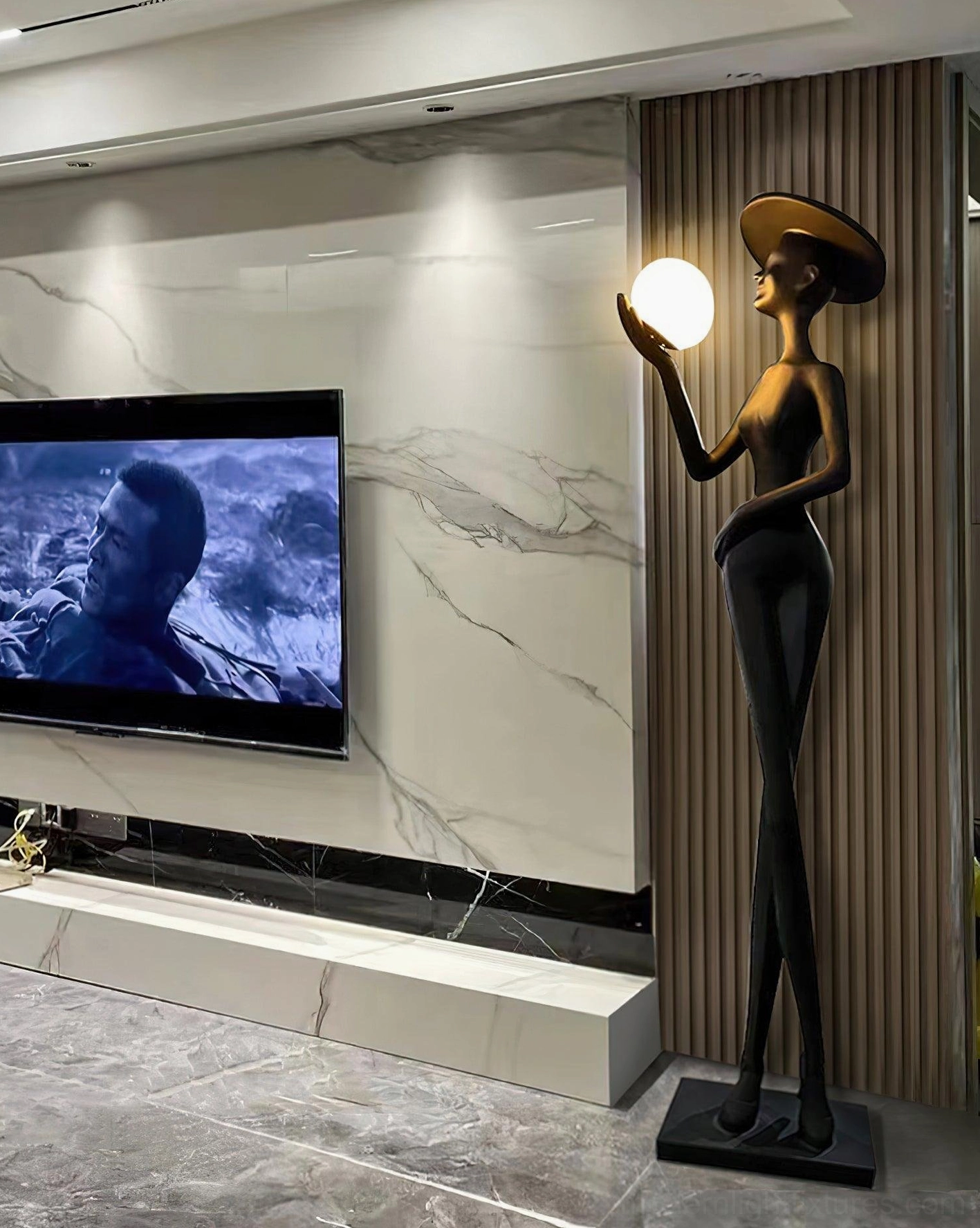 Lexa modern floor lamp in luxury living room with marble accent wall and TV, contemporary home lighting fixture