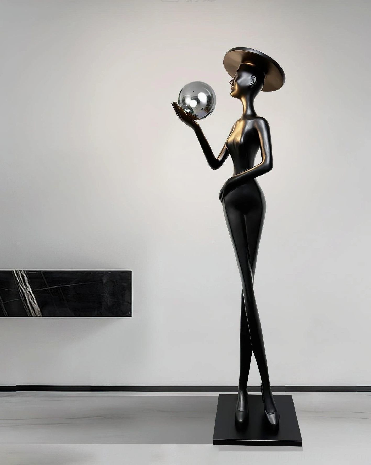 Lexa contemporary sculpture floor lamp with matte black finish and silver metallic sphere in minimalist room with wall shelf