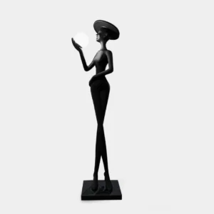 Lexa modern sculpture floor lamp with matte black finish and illuminated white sphere crown, three-quarter left view studio photography
