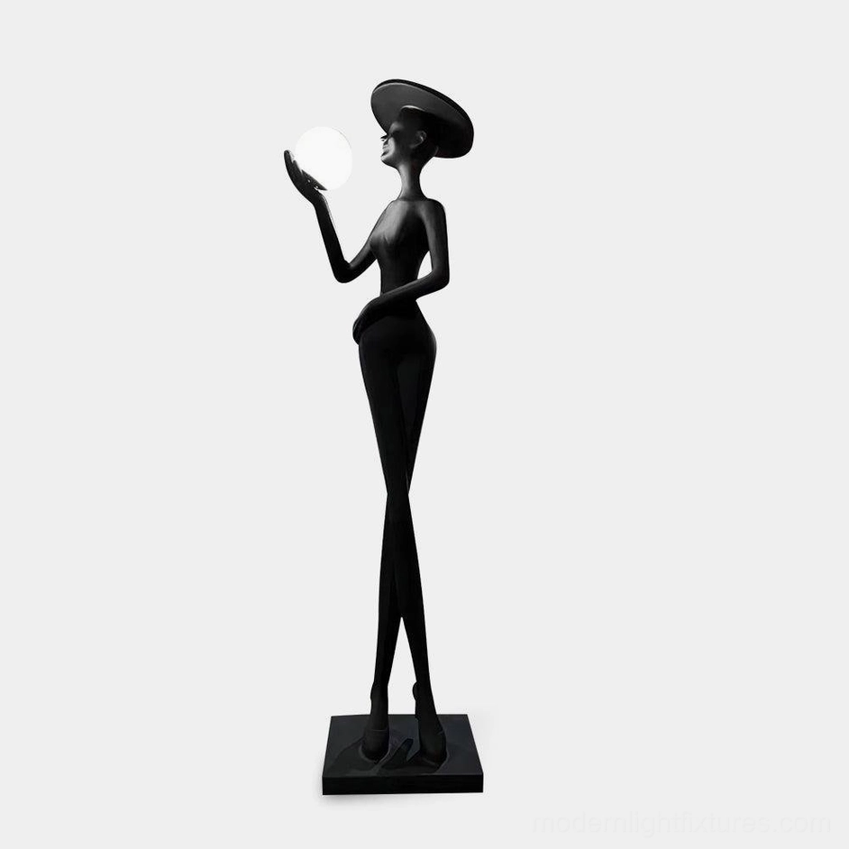 Lexa modern sculpture floor lamp with matte black finish and illuminated white sphere crown, three-quarter left view studio photography