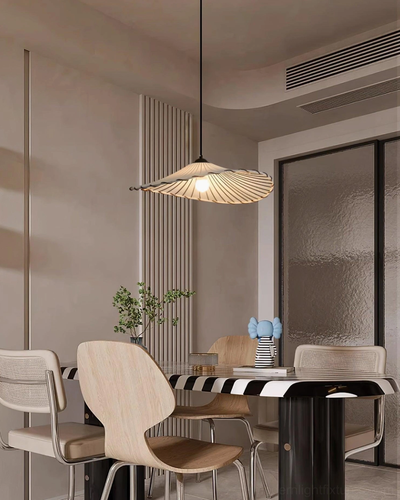 Liana handcrafted pendant lamp installed in dining nook with natural wood table and warm decor