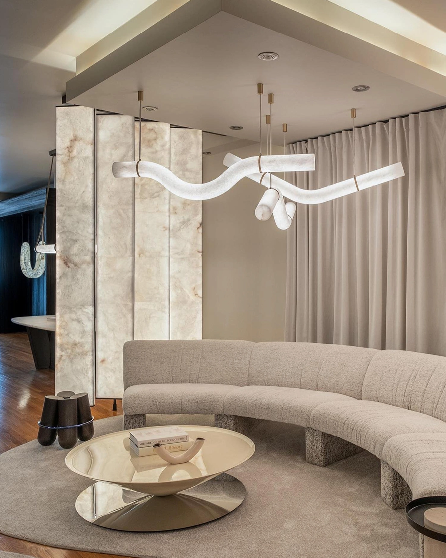 Dual wavy alabaster linear chandeliers living room modern curved sofa warm ambient lighting installation
