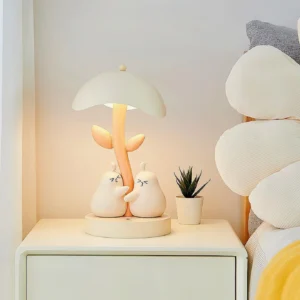 Light gray pear hug bedside table lamp on bedroom nightstand three-quarter view