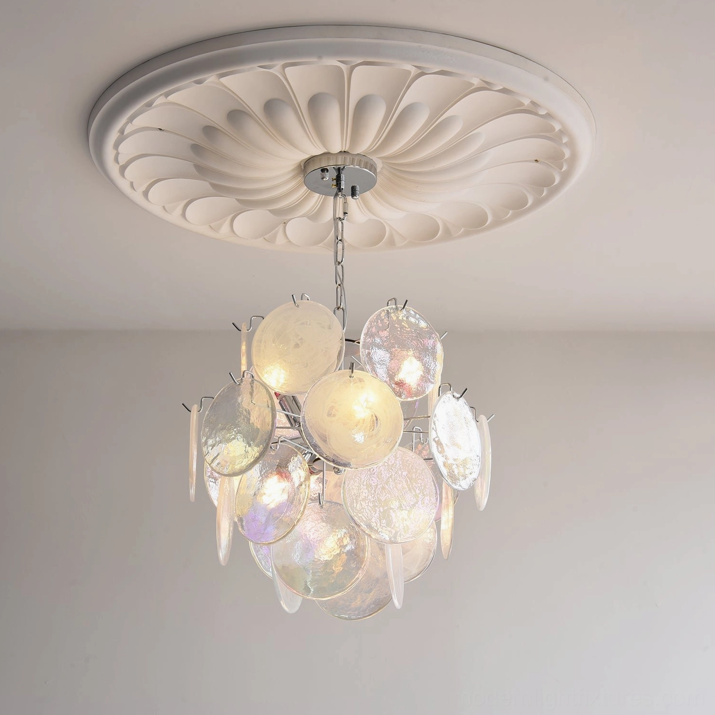 Artistic view of glass disc modern chandelier showing light refraction and pastel iridescent colors